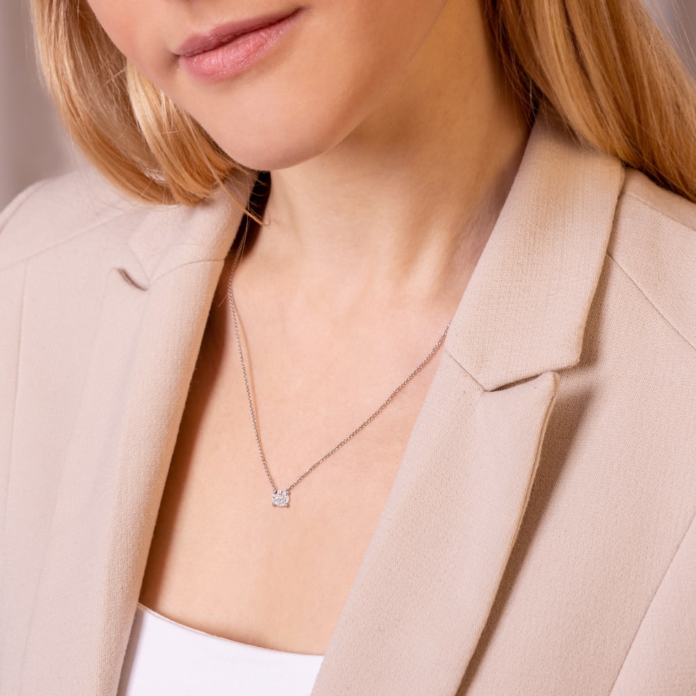 A woman wearing an elegant pendant with labgrown diamond